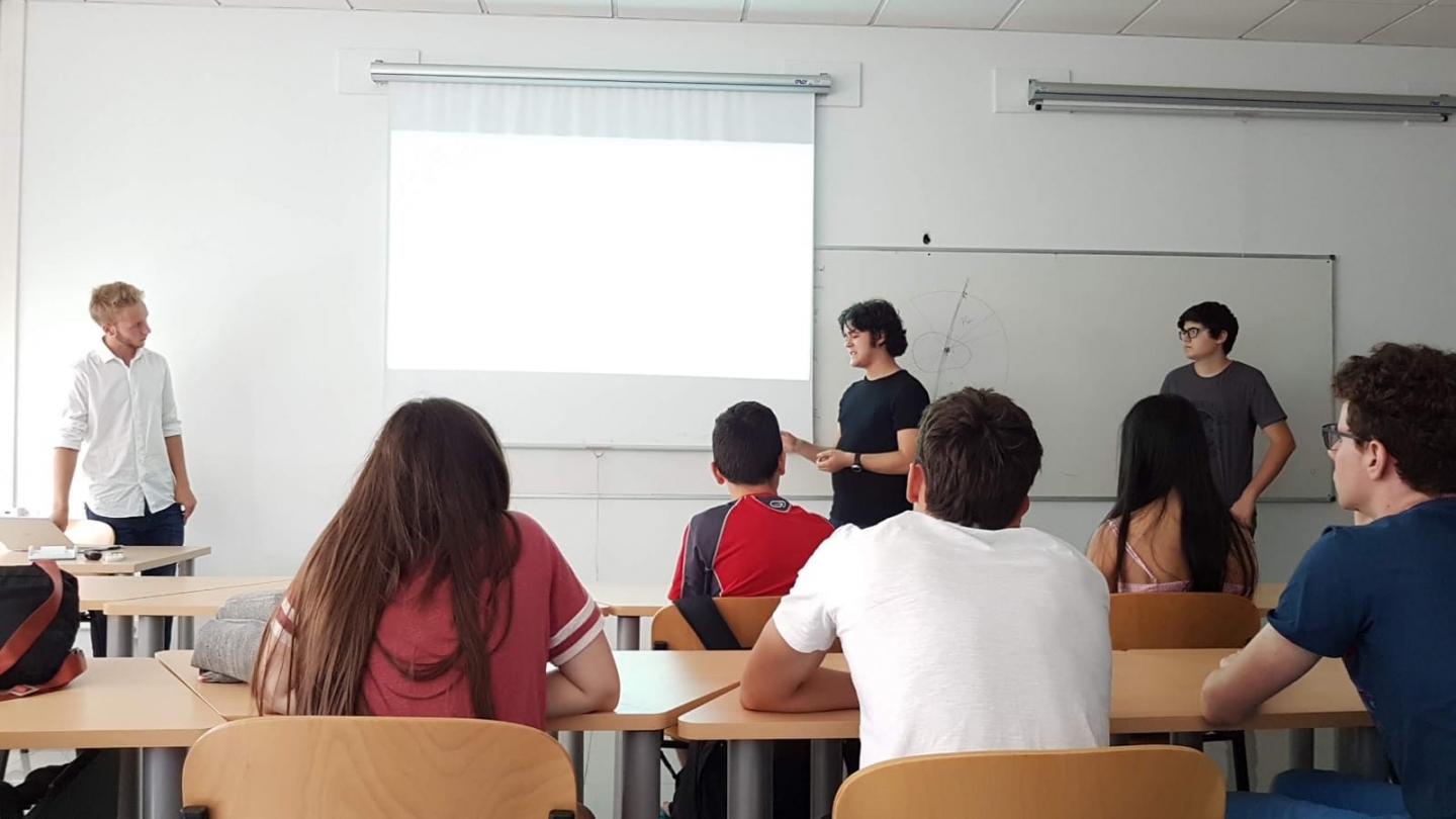 Students presenting in front of a classroom.