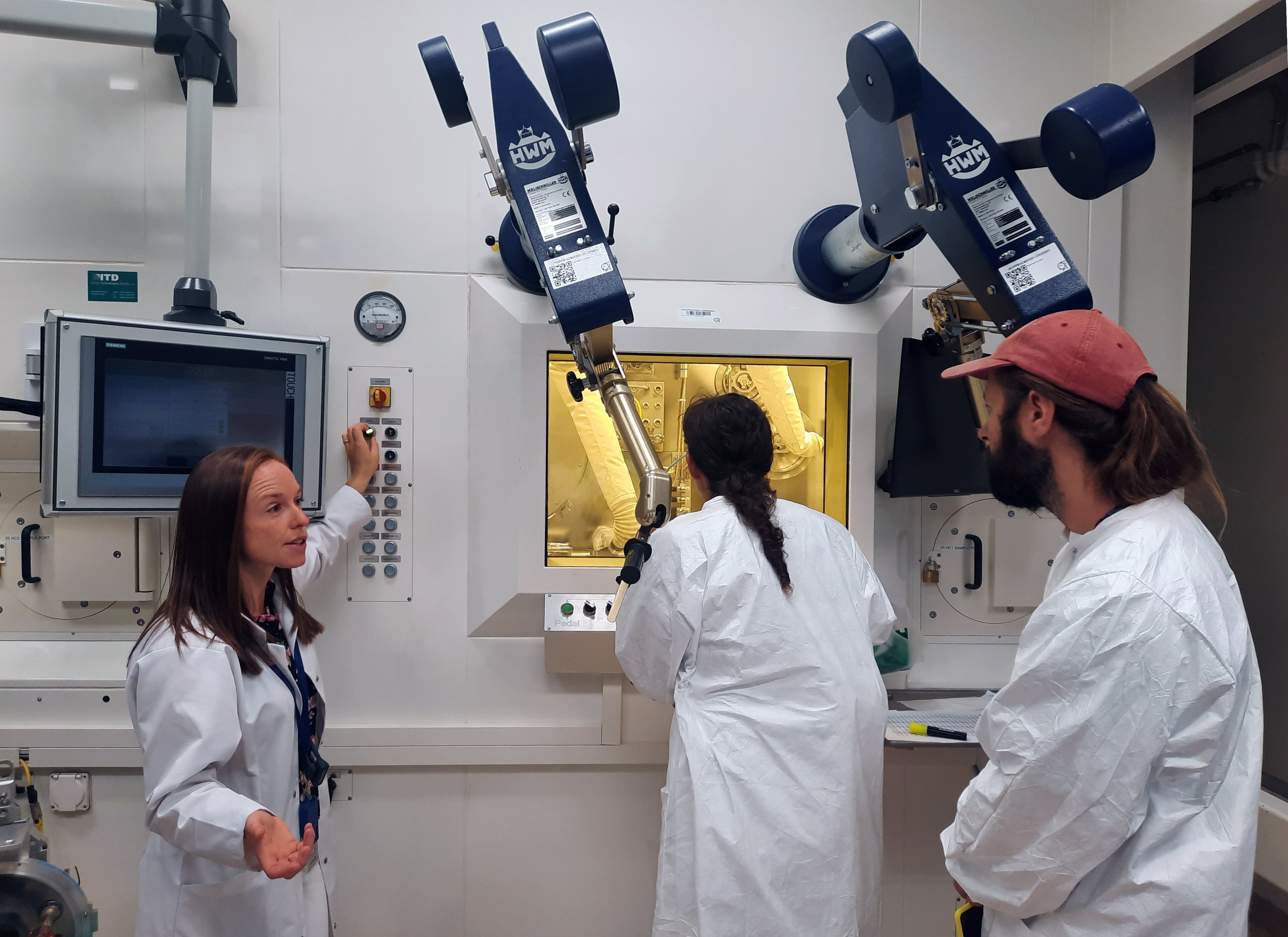 Swiss artists Andrea Anner and Thibault Brevet (AATB) with scientist Laura Lambert at the MEDICIS facility during their residency with Arts at CERN (image: CERN)