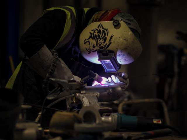 “The Welder” by Margit Pinggera. Welder working at CERN’s main workshop.