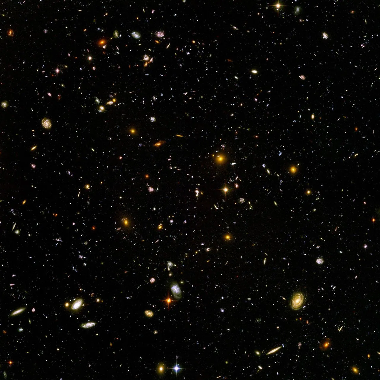 The Hubble Ultra Deep Field, is an image of a small region of space in the constellation Fornax, composited from Hubble Space Telescope data accumulated over a period from September 3, 2003 through January 16, 2004. The patch of sky in which the galaxies reside was chosen because it had a low density of bright stars in the near-field. Image credit: NASA and the European Space Agency