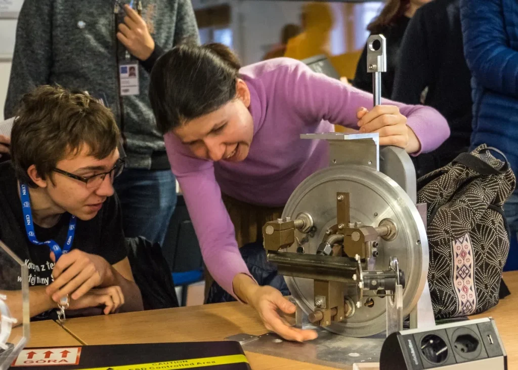 Scientist shows student equipment