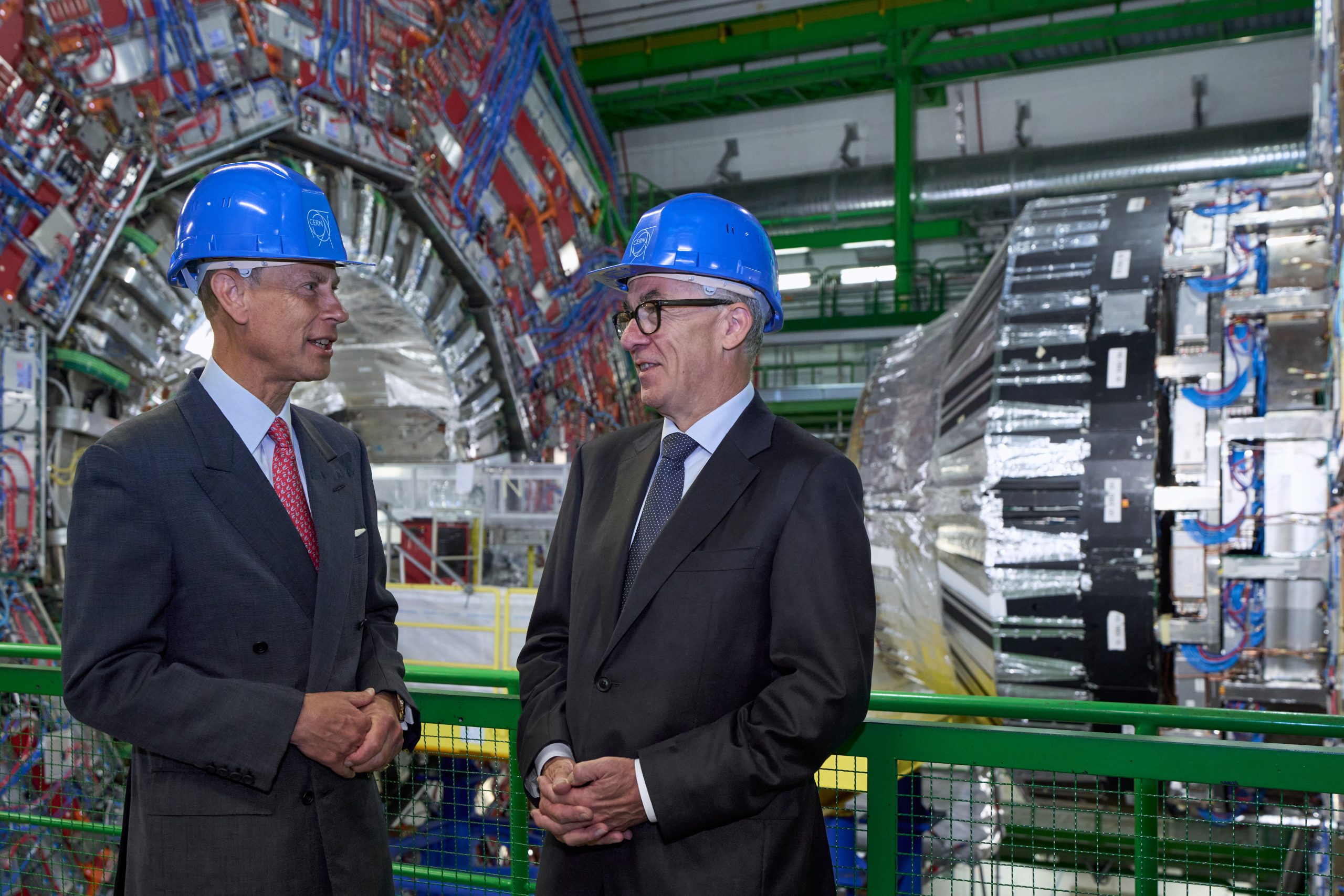 Prince Edward and Mark Thomson talking in front of the CMS detector